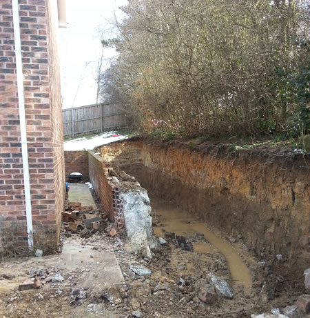 Excavation and removal of the original retaining wall.