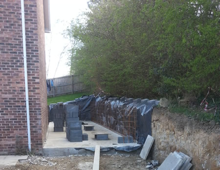 Foundation Slab cast and new structural retaining wall under construction.